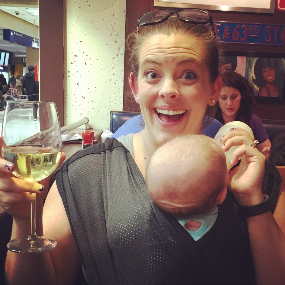 mom smiling with baby and glass of wine, mom sobriety journey