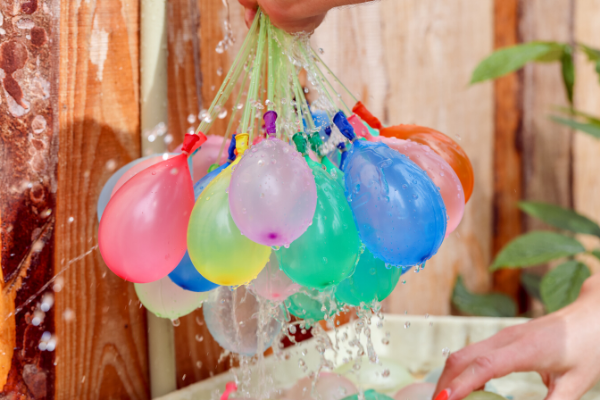 filling bunch of water balloons, summer toys for kids