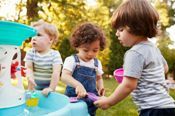 toddlers playing at water table, summer toys for kids