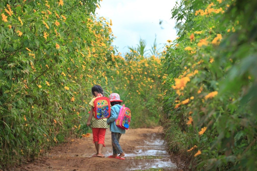 children walking on muddy path