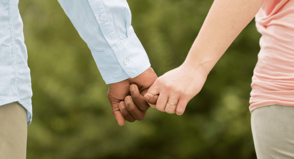 Interracial couple holding hands
