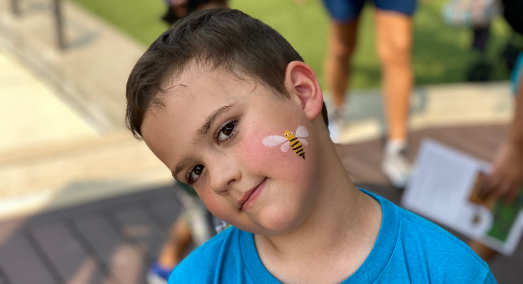 child with a bee face painting at Critter Club presentation
