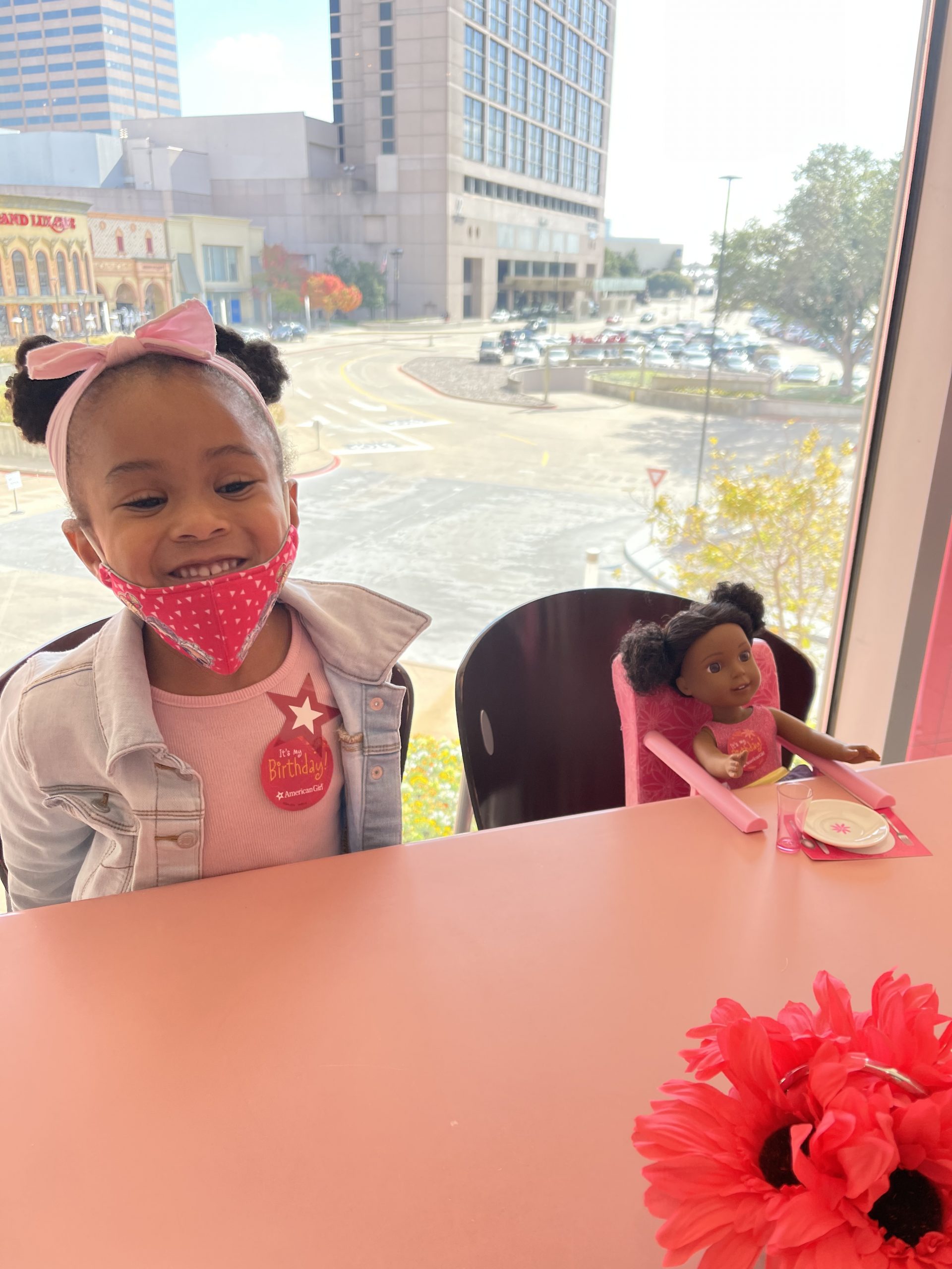 Happy child and her doll at the American Girl Store Bistro in Dallas