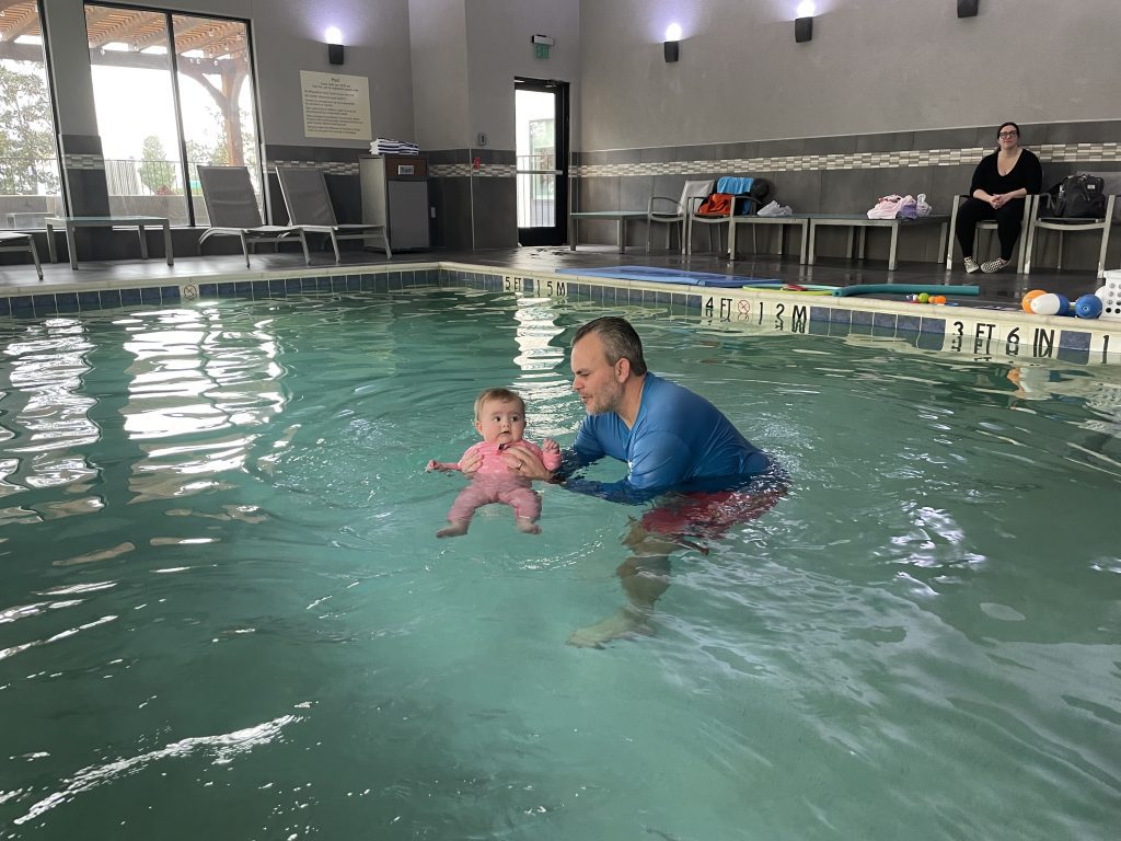baby in pool with instructor, swim lessons near me with Solari Swim School