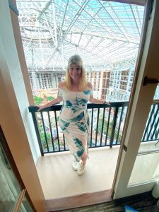 woman posing on balcony at Gaylord Texan, DFW staycations