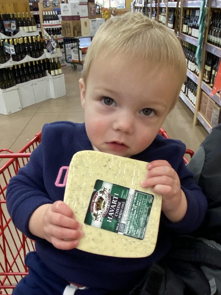 child with cheese in shopping cart: what to buy at trader joe's