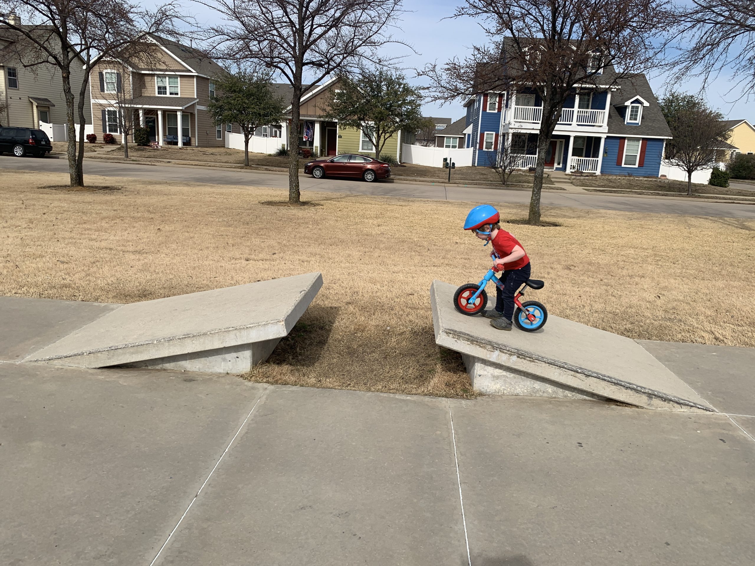 little boy attempting to jump a ramp on his bike, how to raise kids with a growth mindset