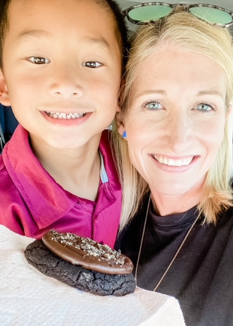 mom and son smiling with crumbl cookie, kid date ideas in dallas