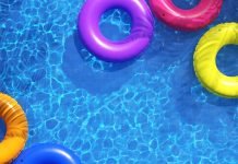 view from above of pool with several colorful inner tubes