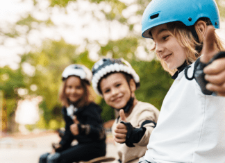 3 kids giving thumbs up in skateboarding gear, how to raise kids with a growth mindset