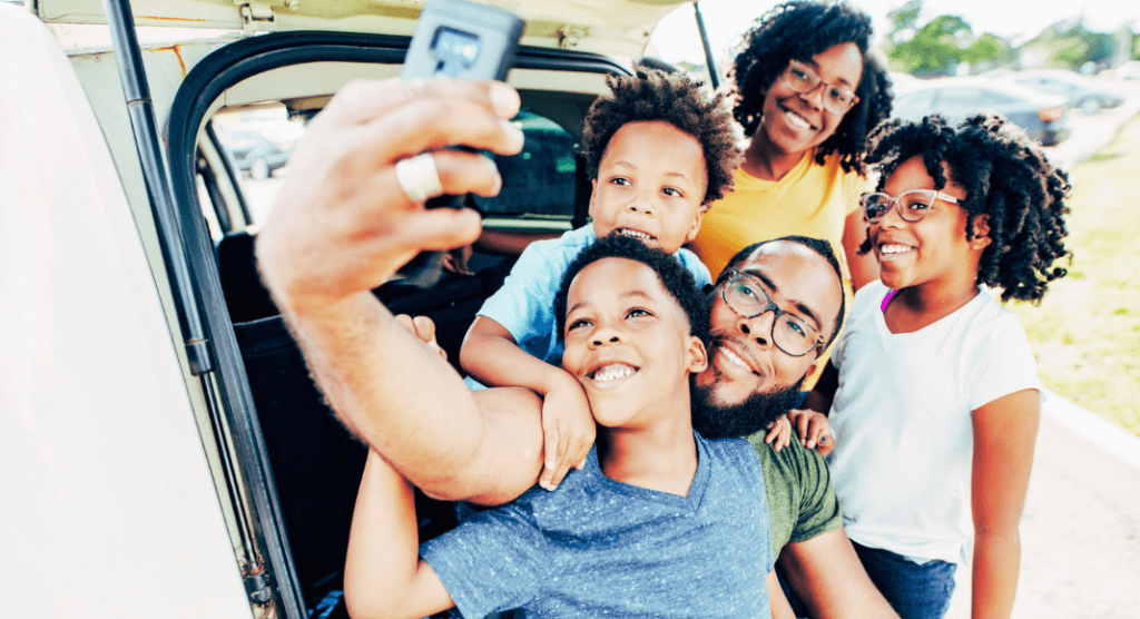 big family selfie in back of car, best kids podcasts for a road trip
