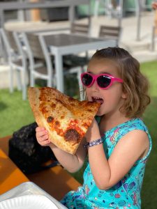 child eating pizza at legacy food hall