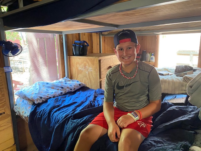 boy in summer camp cabin