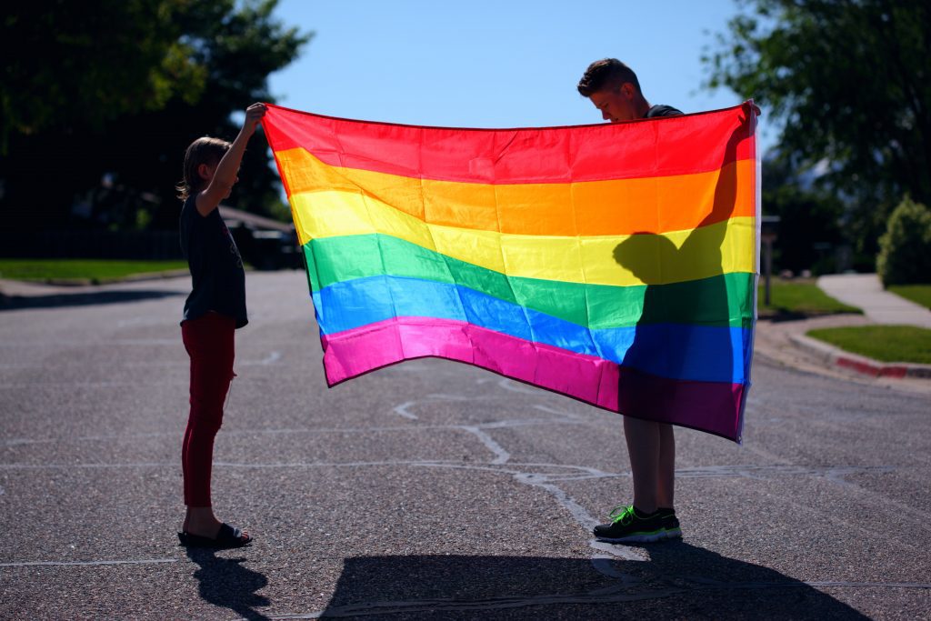 holding up pride flag, family Pride events in Dallas