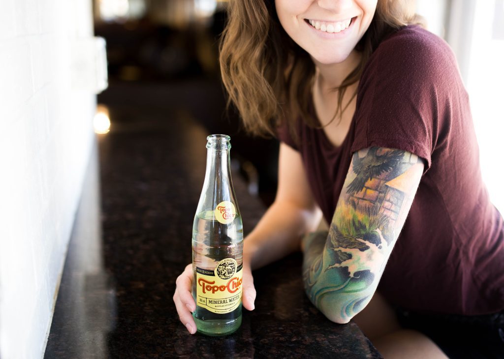 woman with topo chico, take a break from alcohol