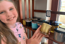 girl smiling and holding a candle at Rocky Creek Candle Company