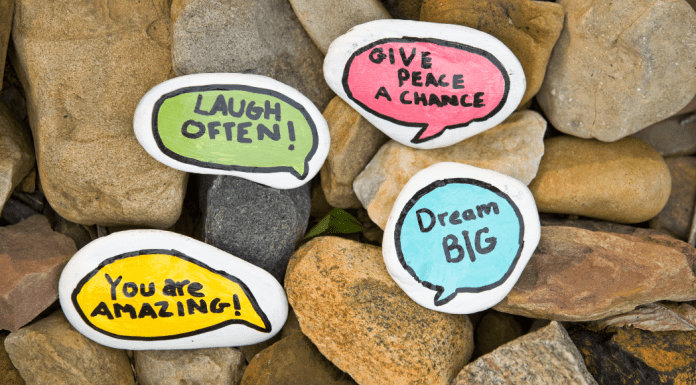 Painted rocks with sweet, kind notes like "Laugh often" and "Dream big."