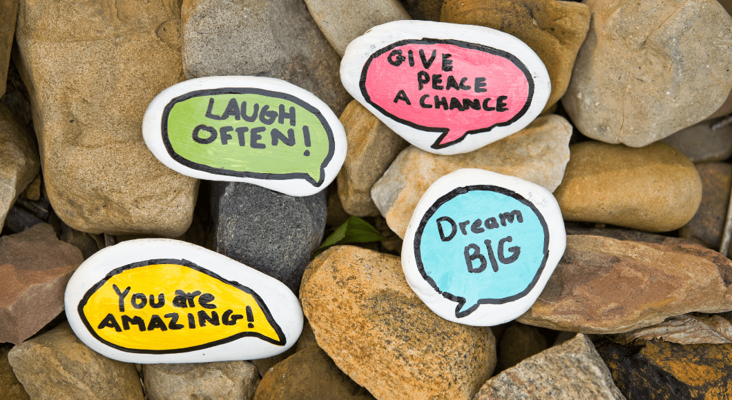 Painted rocks with sweet, kind notes like "Laugh often" and "Dream big."