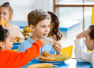 Child eating at school with friends