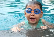Young child with goggles swimming