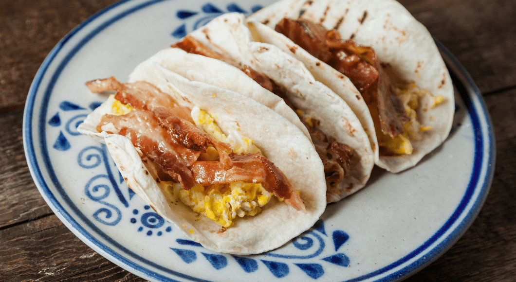 Three breakfast tacos on a plate.