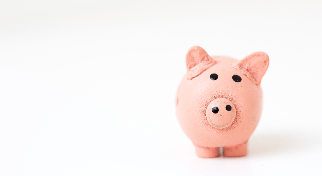 Right aligned pink piggy bank over white background 