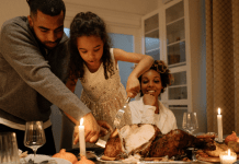 family cutting Thanksgiving turkey