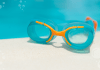 swim goggles on edge of pool