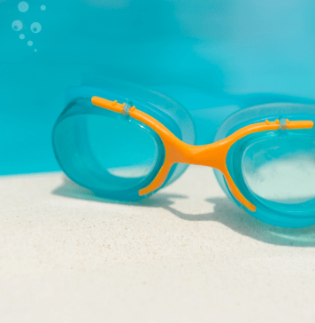 swim goggles on edge of pool