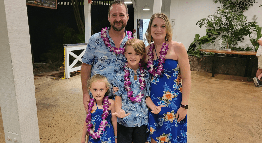 Family of four in matching Hawaiian outfits