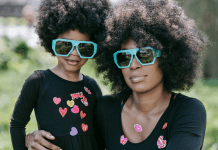 Mother and daughter in matching sunglasses and tshirts.