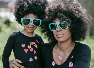Mother and daughter in matching sunglasses and tshirts.
