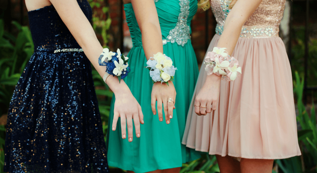 Trio of girls show off their corsages. 