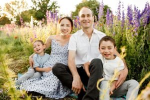 A family of four poses for a portrait with Texas wildflowers.